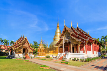 Chapel and golden pagoda at Wat Phra Singh Woramahawihan, famous travel destination in Chiang Mai, Thailand