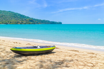 Kamala Beach with crystal clear water and kayak or sea canoe boat, famous tourist destination, Phuket, Thailand