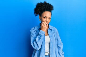 Fototapeta na wymiar Young african american girl wearing casual clothes looking stressed and nervous with hands on mouth biting nails. anxiety problem.