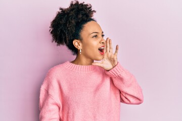 Young african american girl wearing casual clothes shouting and screaming loud to side with hand on mouth. communication concept.