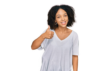 Young african american girl wearing casual clothes doing happy thumbs up gesture with hand. approving expression looking at the camera showing success.