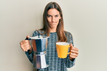 Young beautiful woman drinking italian coffee skeptic and nervous, frowning upset because of problem. negative person.