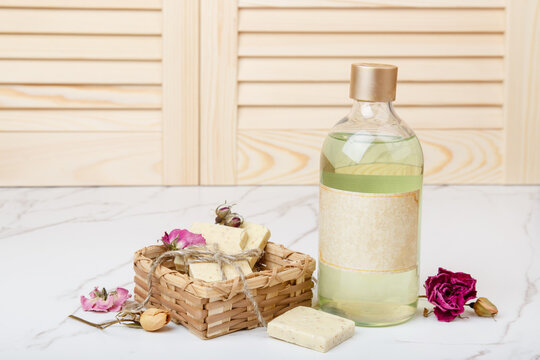 Natural soap with rose flowers. Face care products. Prepare to bath. Spa therapy concept photo. Organic cosmetic on wooden and marble background. Cosmetics for relax and aromatherapy. home hygiene