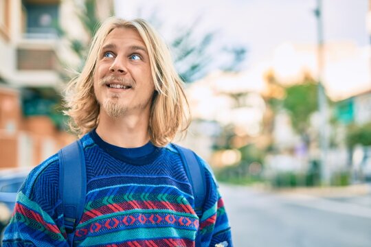 Young scandinavian student man smiling happy standing at the city.