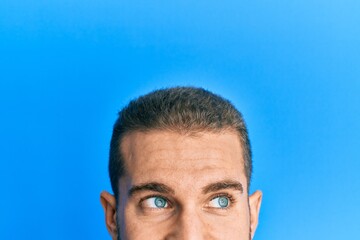 Young caucasian man showing head and half face smiling looking to the side and staring away thinking.