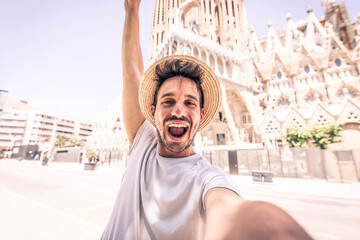Happy tourist visiting La Sagrada Familia, Barcelona Spain - Smiling man taking a selfie outdoor on...