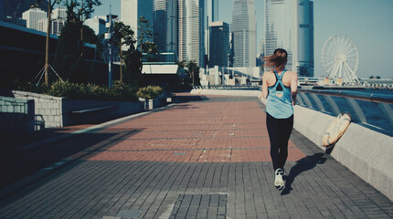 Young, attractive woman jogging in the city.