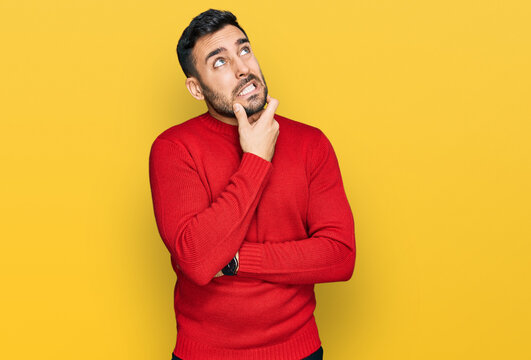 Young hispanic man wearing casual clothes thinking worried about a question, concerned and nervous with hand on chin