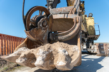 The bucket of an old quarry excavator is a close-up. The crawler excavator is located on the territory of a mining quarry. an open method of mining.