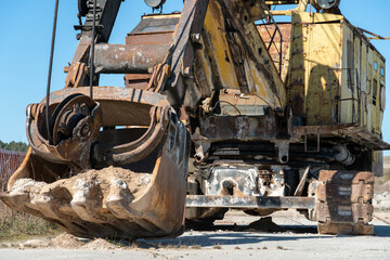 Fototapeta premium an old rusty quarry excavator is located on the territory of a mining quarry. an open method of mining.