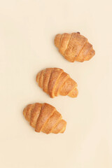 freshly baked croissants on a light background, top view