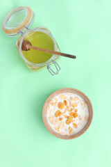 Flakes in milk for breakfast with honey on a light background. Breakfast concept.