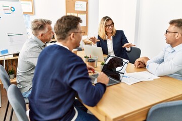 Group of middle age business workers working at the office.