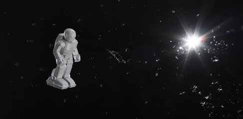 Fototapeta na wymiar toy astronaut on a black sky