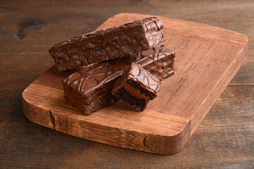 three sliced chocolate bar cakes on cutting board