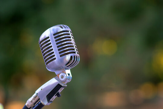 Retro style silver microphone on blur background