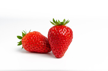 Two ripe red strawberries isolated on a white background
