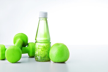 Organic food and sport equipment on light grey background with copy space. Healthy life style food fitness concept.