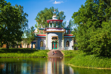 An exotic pavilion or Chinese gazebo (Creaking gazebo) on the shore of a pond in the Catherine Park...