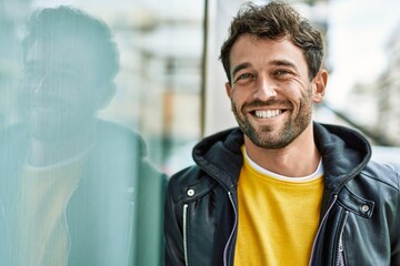 Handsome hispanic man with beard smiling happy outdoors