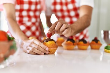 Obraz na płótnie Canvas Hands of couple cooking pumpkins at kitchen.
