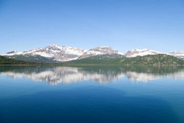 reflection of mountains in ocean