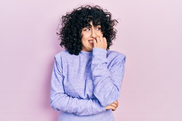 Young middle east woman wearing casual clothes looking stressed and nervous with hands on mouth...