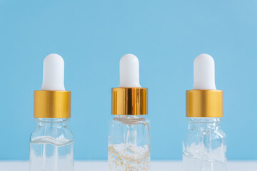 bottles with serum on blue background. dropper bottle with natural organic cosmetic. SPA, skincare, body treatment concept
