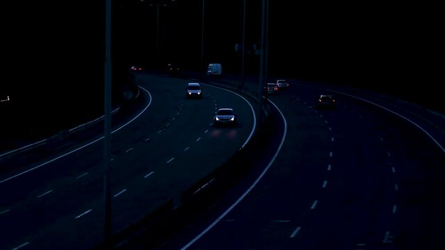Driving a car on the highway in the evening with the headlights on. Dori and vehicles.