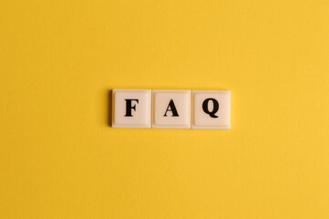 Square letters with text FAQ isolated on yellow background
