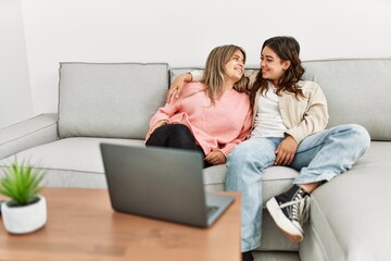 Young couple watching film sitting on the sofa at home.