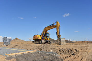 Fototapeta na wymiar Excavator during earthmoving work at construction site.