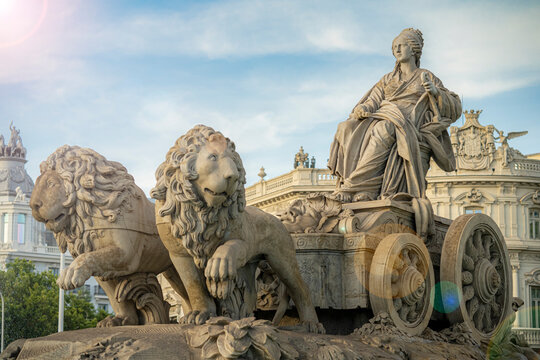 Statue of the goddess Cibeles and the lions in the city of Madrid, Spain, during a sunny summer day with few clouds