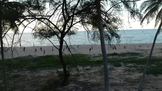 People play beach soccer  seaside ,drone shot top view aerial view background landscape 
