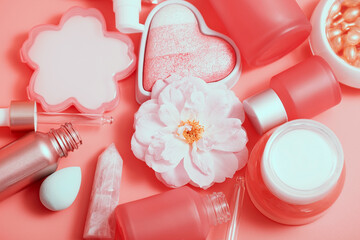 Obraz na płótnie Canvas Cosmetic bottles and jars on a pink monochrome background. Asian cosmetics for skin care close-up