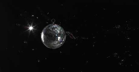 silver disco ball on black background