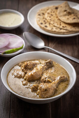 cream chicken curry with flatbread chapati or parantha