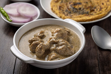 cream chicken curry with flatbread chapati or parantha