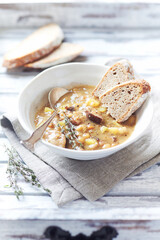 Pea soup on bright wooden background.