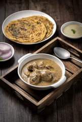 cream chicken curry with flatbread chapati or parantha