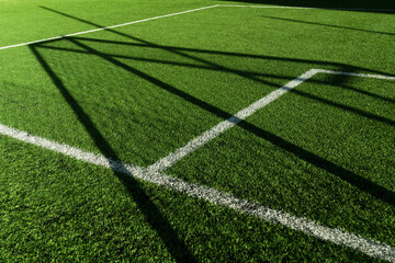 green artificial grass football or soccer field with white line background.