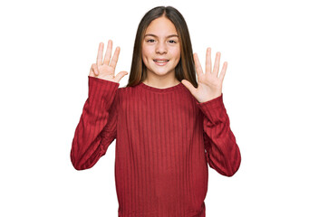 Beautiful brunette little girl wearing casual sweater showing and pointing up with fingers number...