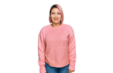 Hispanic woman with pink hair wearing casual winter sweater with a happy and cool smile on face....