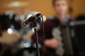 Microphone On Stage Close-up. Blurred Background Musician Playing