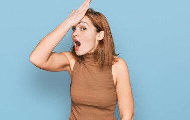 Fototapeta premium Young caucasian woman wearing casual clothes surprised with hand on head for mistake, remember error. forgot, bad memory concept.