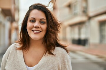 Young irish plus size girl smiling happy standing at the city.