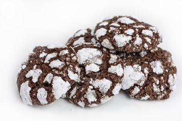 heap of chewy chocolate crinkle cookies with confectioners sugar