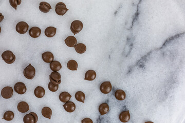background of sweet milk chocolate drops on marble