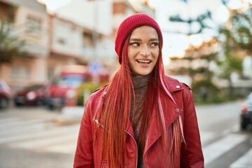 Young caucasian girl smiling happy standing at the city.