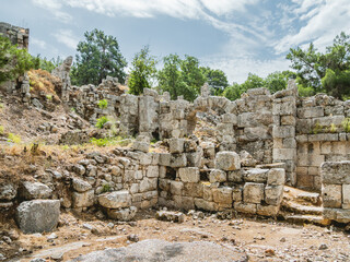 Fototapeta na wymiar Ruins of large bath of ancient Phaselis city. Famous architectural landmark, Kemer district, Antalya province. Turkey.